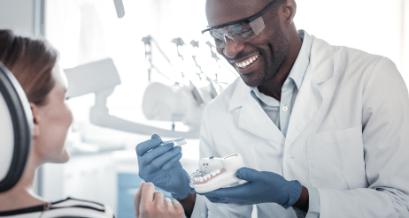 dentist-talking-to-his-patient-while-smiling